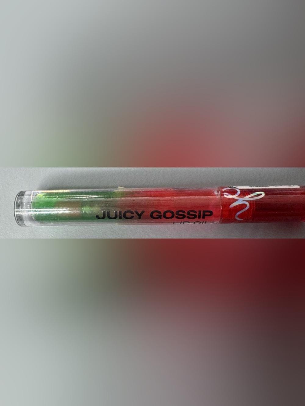 Juicy Gossip Red & Green Lip Oil in watermelon clear glossy